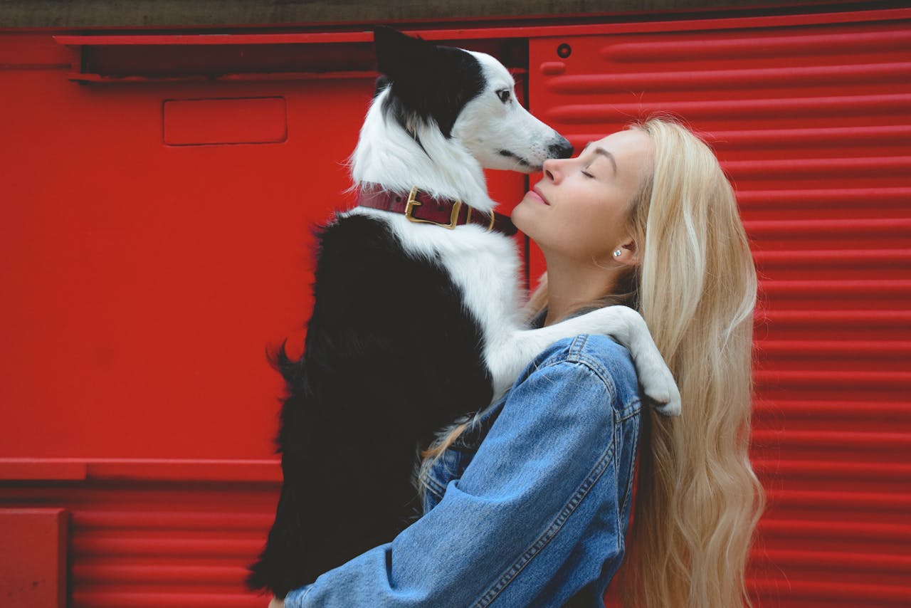 A Woman Holding a Dog